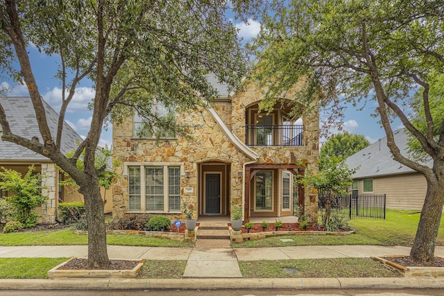 7605 Chief Spotted Tail Dr, Mckinney, TX 75070 - view of front facade featuring a balcony and stone siding