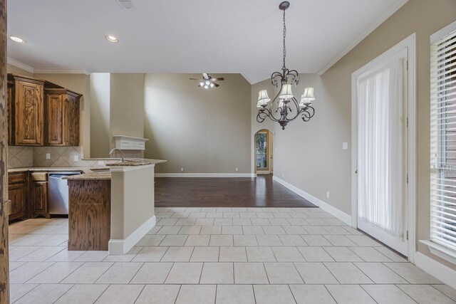 7605 Chief Spotted Tail Dr, Mckinney, TX 75070 - kitchen with ornamental molding, open floor plan, dishwasher, ceiling fan, and backsplash
