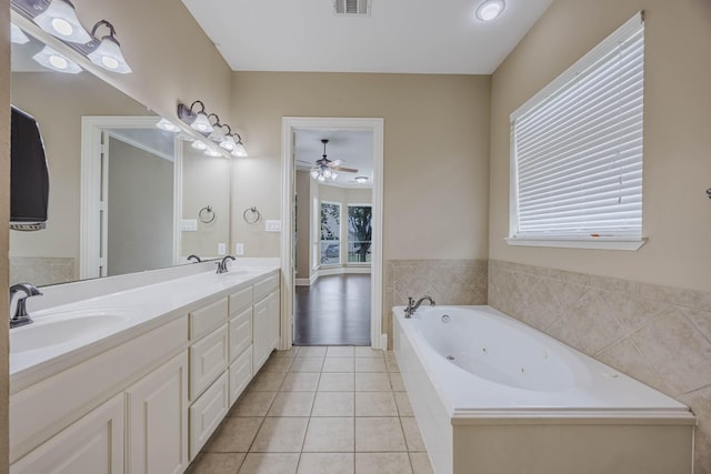 7605 Chief Spotted Tail Dr, Mckinney, TX 75070 - bathroom featuring double vanity, ceiling fan, a tub with jets, and tile patterned floors