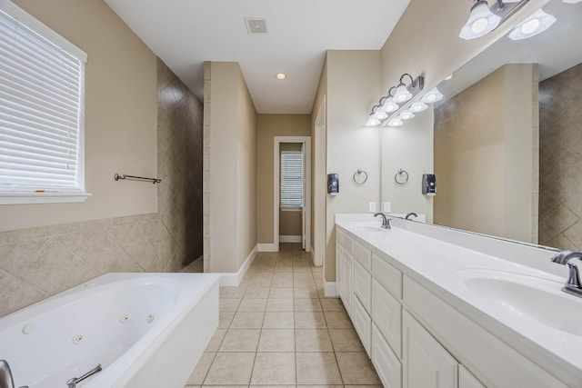 7605 Chief Spotted Tail Dr, Mckinney, TX 75070 - bathroom featuring double vanity, a tub with jets, tile patterned flooring, and baseboards