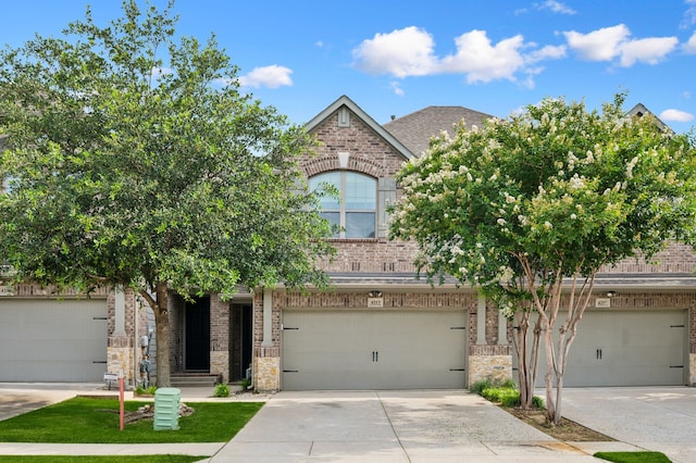 4213 Tallulah Dr, Plano, TX 75074 - view of property hidden behind natural elements featuring brick siding, concrete driveway, an attached garage, stone siding, and roof with shingles