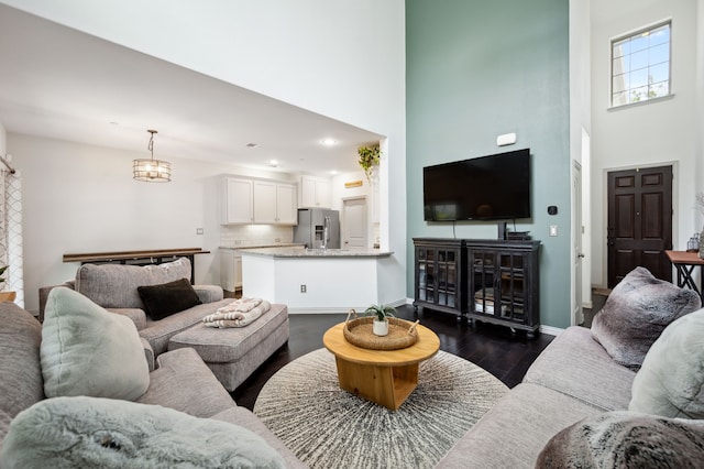 4213 Tallulah Dr, Plano, TX 75074 - living room featuring a high ceiling, dark wood-type flooring, and baseboards