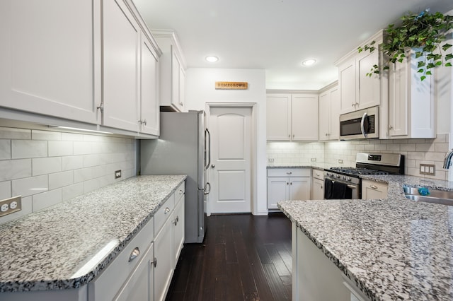 4213 Tallulah Dr, Plano, TX 75074 - kitchen with appliances with stainless steel finishes, a sink, backsplash, light stone countertops, and recessed lighting