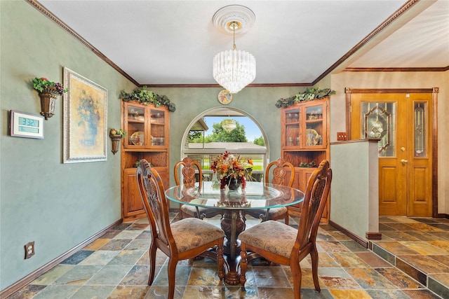 2514 Good Shepherd Dr, Brownwood, TX 76801 - dining space featuring stone tile floors, a chandelier, baseboards, and crown molding