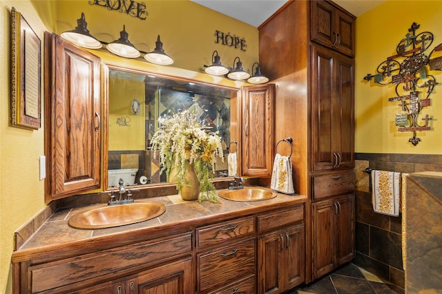 2514 Good Shepherd Dr, Brownwood, TX 76801 - full bath with double vanity, tile patterned flooring, and tile walls