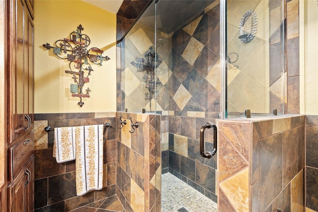 2514 Good Shepherd Dr, Brownwood, TX 76801 - full bathroom featuring a shower stall, tile walls, and wainscoting