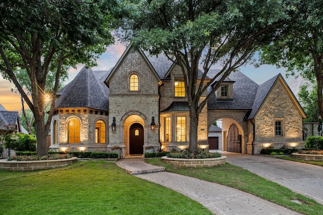 6131 Arboretum Dr, Frisco, TX 75034 - french country inspired facade with stone siding, a lawn, driveway, and brick siding