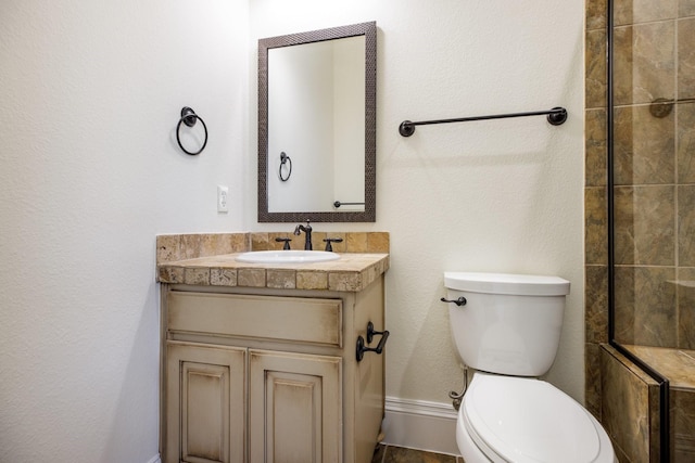 6131 Arboretum Dr, Frisco, TX 75034 - bathroom featuring toilet, vanity, and a tile shower