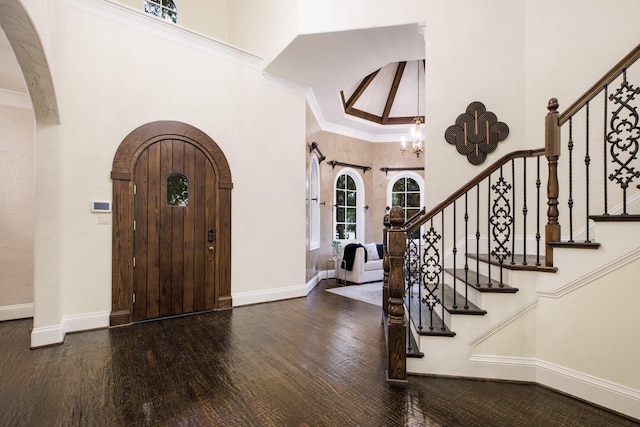 6131 Arboretum Dr, Frisco, TX 75034 - entrance foyer with arched walkways, a high ceiling, wood finished floors, a chandelier, and baseboards