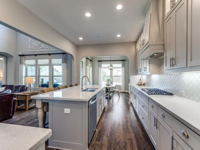 3051 Kennington Dr, Prosper, TX 75078 - kitchen with a sink, arched walkways, stainless steel appliances, dark wood-style floors, and custom range hood