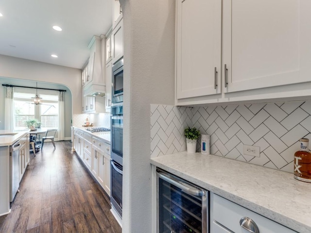 3051 Kennington Dr, Prosper, TX 75078 - kitchen with beverage cooler, tasteful backsplash, white cabinets, dark wood-style floors, and light stone counters