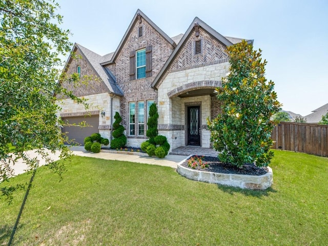 3051 Kennington Dr, Prosper, TX 75078 - french provincial home featuring stone siding, a garage, driveway, and brick siding