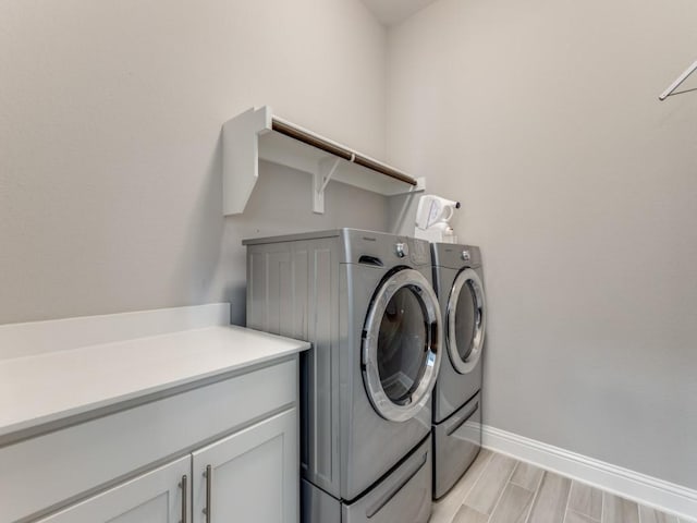 3051 Kennington Dr, Prosper, TX 75078 - laundry area with independent washer and dryer, baseboards, light wood-type flooring, and cabinet space