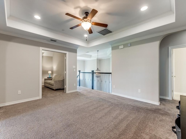 3051 Kennington Dr, Prosper, TX 75078 - carpeted spare room featuring a raised ceiling, ceiling fan, ornamental molding, recessed lighting, and arched walkways
