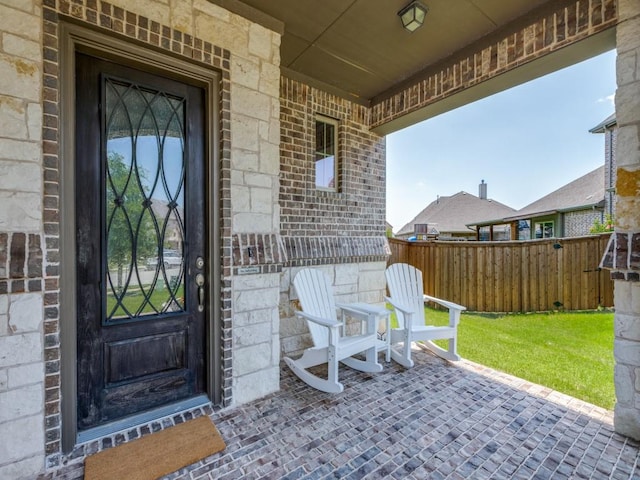 3051 Kennington Dr, Prosper, TX 75078 - doorway to property with a porch, brick siding, and stone siding
