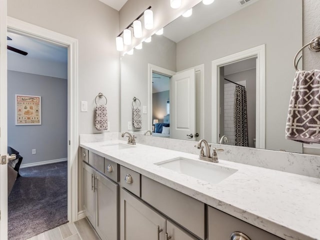 3051 Kennington Dr, Prosper, TX 75078 - ensuite bathroom with double vanity, baseboards, and wood finished floors