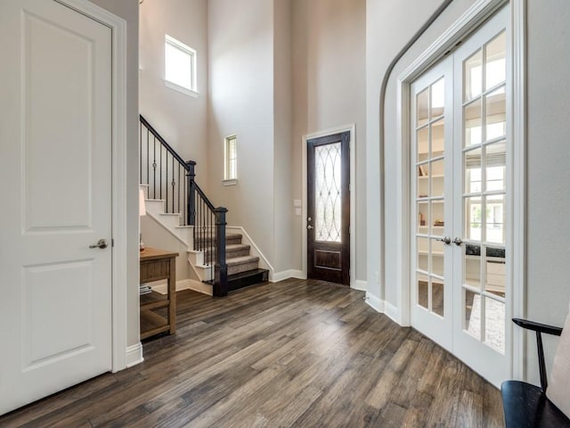 3051 Kennington Dr, Prosper, TX 75078 - entrance foyer with dark wood-type flooring, french doors, stairs, a towering ceiling, and baseboards