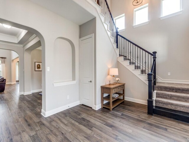 3051 Kennington Dr, Prosper, TX 75078 - entryway featuring dark wood-style flooring, stairway, arched walkways, ornamental molding, and baseboards