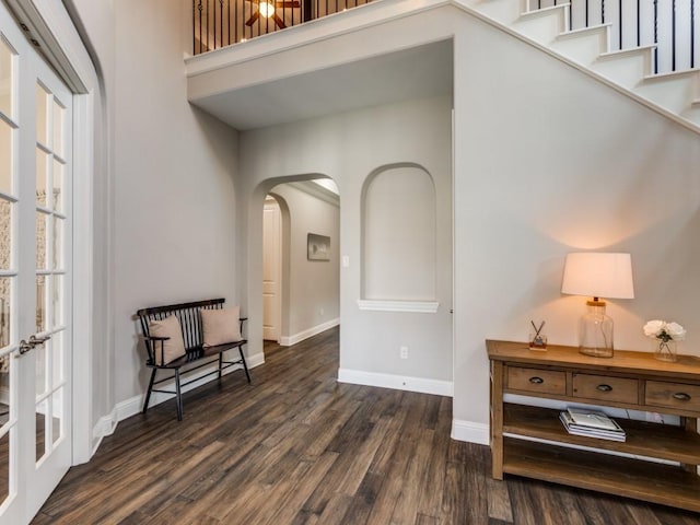 3051 Kennington Dr, Prosper, TX 75078 - living area featuring arched walkways, dark wood-style floors, baseboards, and a high ceiling