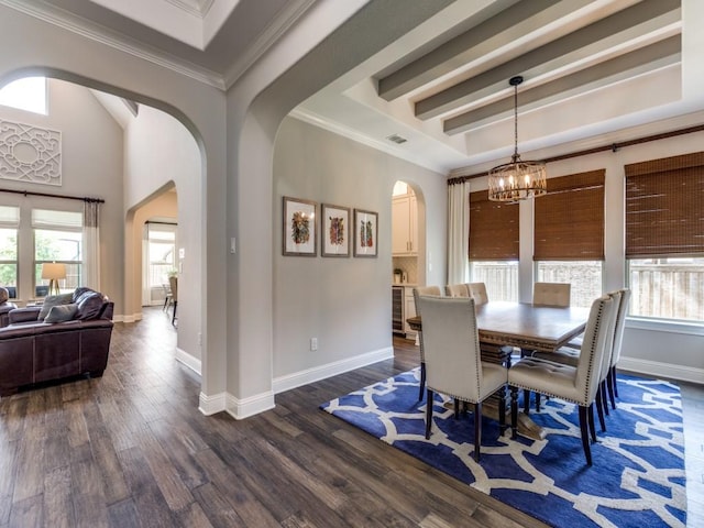 3051 Kennington Dr, Prosper, TX 75078 - dining space with arched walkways, a chandelier, dark wood-style flooring, baseboards, and crown molding