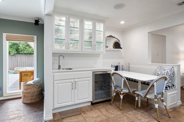 6533 Axton Cir, Dallas, TX 75214 - indoor wet bar with beverage cooler, ornamental molding, and recessed lighting