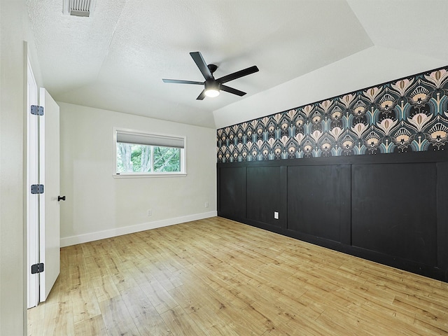 351 Oak Creek Dr, New Hope, TX 75071 - unfurnished room with lofted ceiling, wood-type flooring, a ceiling fan, and baseboards