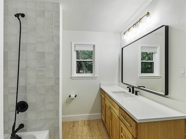 351 Oak Creek Dr, New Hope, TX 75071 - full bath with wood finished floors, vanity, baseboards, shower / bathtub combination, and a textured ceiling