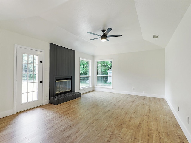 351 Oak Creek Dr, New Hope, TX 75071 - unfurnished living room featuring light wood-style floors, ceiling fan, a tiled fireplace, and vaulted ceiling