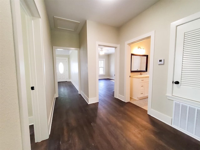 2107 Homan Ave, Waco, TX 76707 - hallway featuring dark wood finished floors and attic access