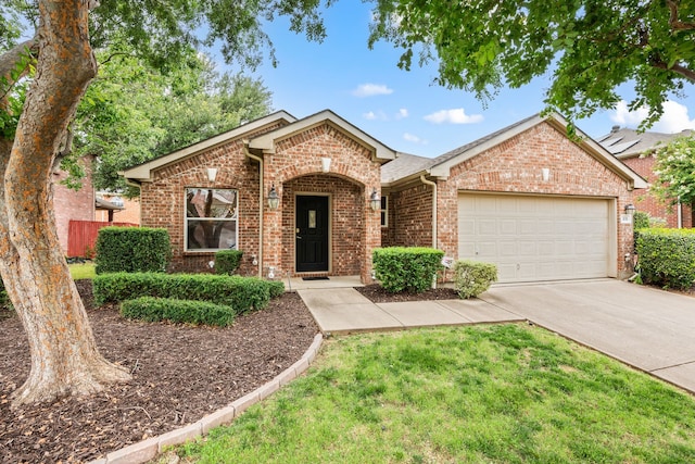 515 Angela Ln, Euless, TX 76039 - view of front facade featuring an attached garage, brick siding, and driveway