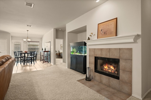 515 Angela Ln, Euless, TX 76039 - carpeted living room featuring a tile fireplace, a chandelier, tile patterned flooring, and healthy amount of natural light