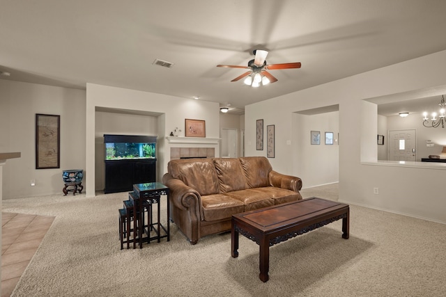 515 Angela Ln, Euless, TX 76039 - carpeted living room with a tiled fireplace, ceiling fan, a chandelier, and baseboards