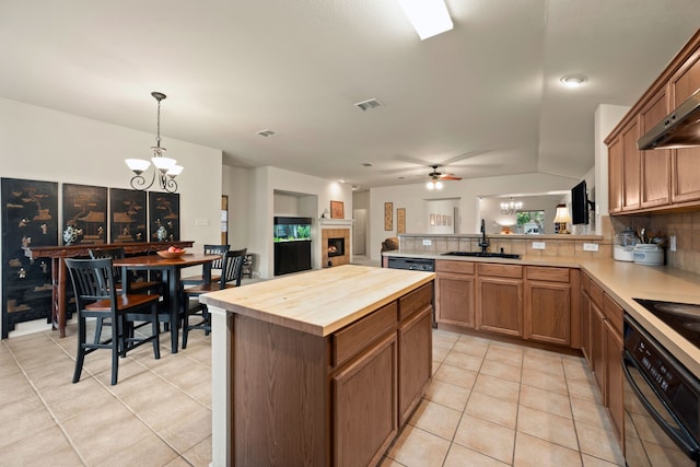 515 Angela Ln, Euless, TX 76039 - kitchen with oven, a chandelier, a sink, butcher block countertops, and a fireplace