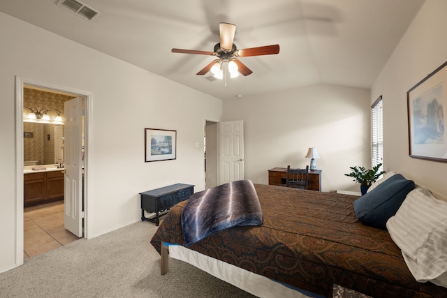 515 Angela Ln, Euless, TX 76039 - bedroom featuring light colored carpet, connected bathroom, vaulted ceiling, ceiling fan, and light tile patterned floors