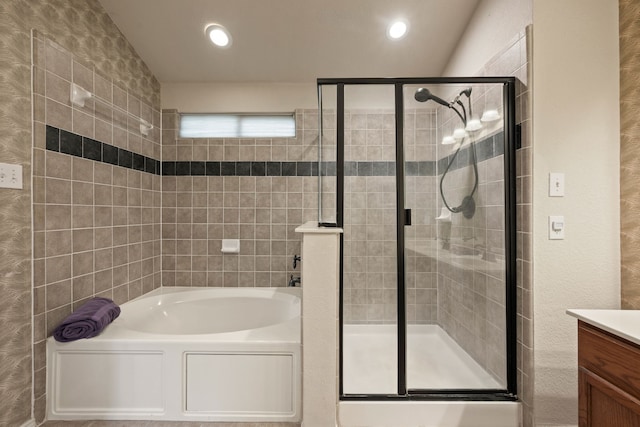 515 Angela Ln, Euless, TX 76039 - bathroom featuring a shower stall, vanity, a bath, recessed lighting, and tile walls