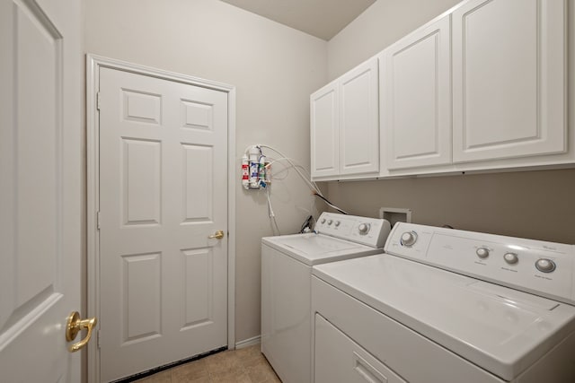 515 Angela Ln, Euless, TX 76039 - laundry area with washing machine and dryer, cabinet space, light tile patterned floors, and baseboards