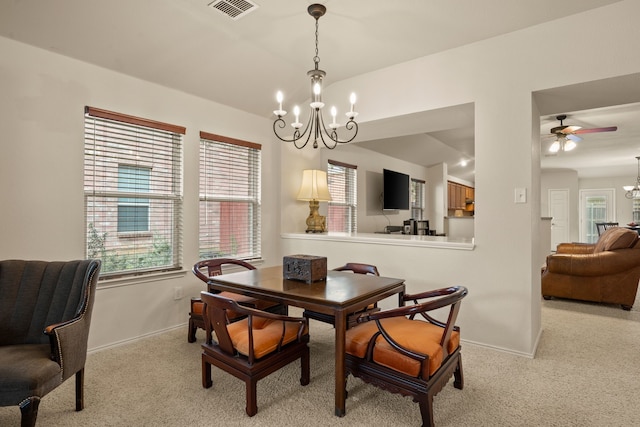 515 Angela Ln, Euless, TX 76039 - dining room with a chandelier, light carpet, baseboards, and ceiling fan