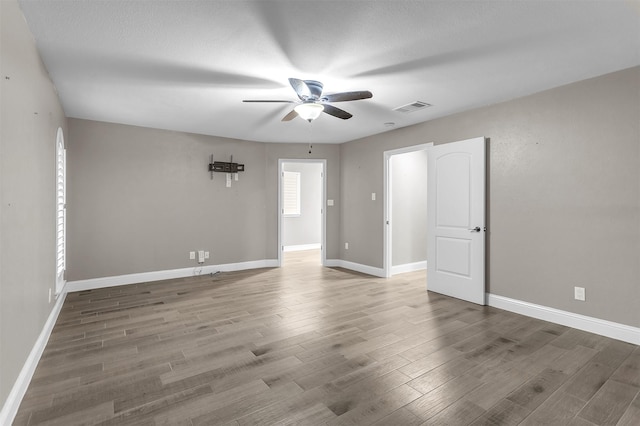 1904 Alston St, Arlington, TX 76013 - unfurnished room with ceiling fan, wood finished floors, and baseboards