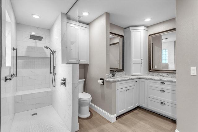 1904 Alston St, Arlington, TX 76013 - full bath with wood finished floors, toilet, vanity, a tile shower, and baseboards
