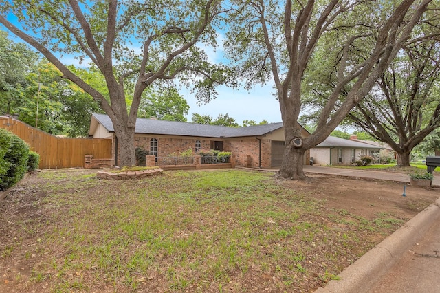 1904 Alston St, Arlington, TX 76013 - mid-century modern home featuring an attached garage, brick siding, and driveway