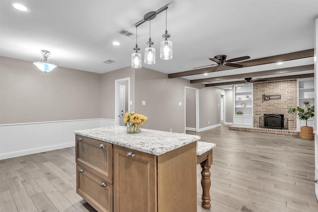 1904 Alston St, Arlington, TX 76013 - kitchen with a ceiling fan, beamed ceiling, light wood finished floors, a kitchen island, and wainscoting
