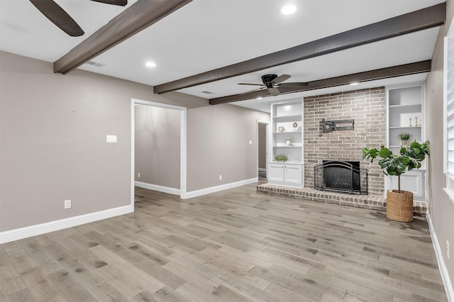 1904 Alston St, Arlington, TX 76013 - unfurnished living room with ceiling fan, baseboards, beam ceiling, light wood-style flooring, and a brick fireplace