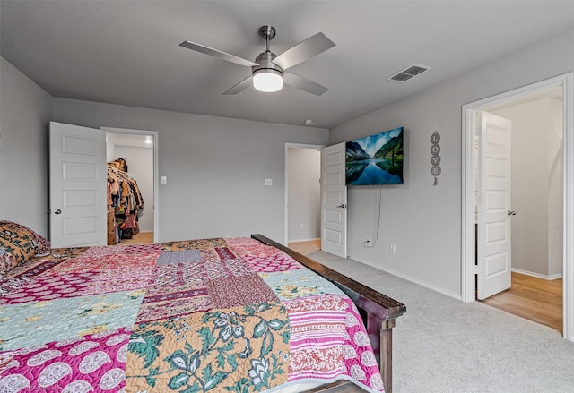 129 Clear Creek Ln, Terrell, TX 75160 - carpeted bedroom with a closet, ceiling fan, baseboards, and a walk in closet