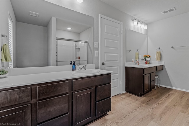 129 Clear Creek Ln, Terrell, TX 75160 - full bathroom with wood finished floors, vanity, and a shower with shower door