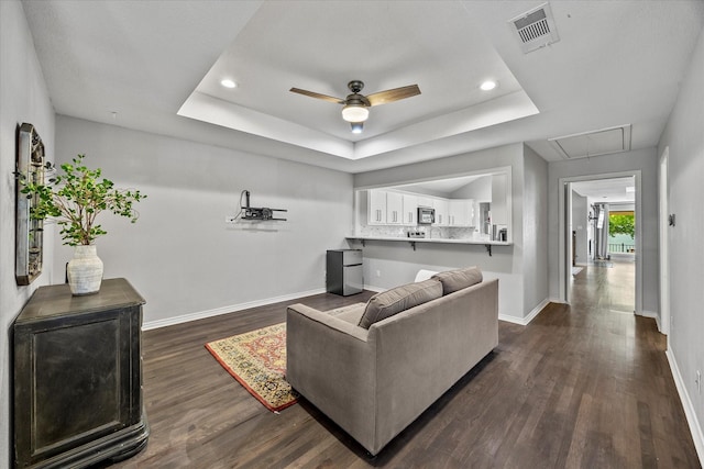 5556 Canada Ct, Rockwall, TX 75032 - living area with attic access, a raised ceiling, baseboards, ceiling fan, and dark wood finished floors
