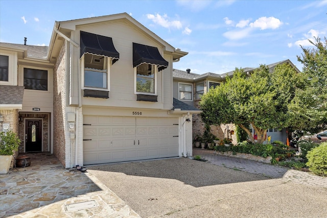 5556 Canada Ct, Rockwall, TX 75032 - view of property featuring driveway, brick siding, and an attached garage