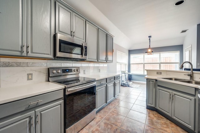 1004 Broken Spoke Dr, Little Elm, TX 75068 - kitchen with appliances with stainless steel finishes, gray cabinets, a sink, and light tile patterned floors