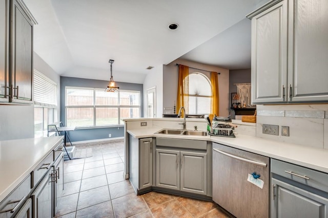 1004 Broken Spoke Dr, Little Elm, TX 75068 - kitchen featuring gray cabinets, stainless steel dishwasher, a sink, a peninsula, and lofted ceiling