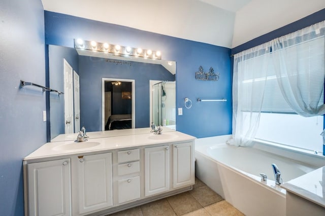 1004 Broken Spoke Dr, Little Elm, TX 75068 - bathroom with a garden tub, double vanity, and tile patterned flooring