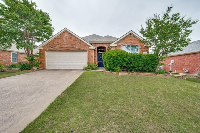 1004 Broken Spoke Dr, Little Elm, TX 75068 - traditional-style house featuring an attached garage, driveway, a front yard, and brick siding